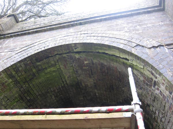 Western end - a wide crack between the brick arch of the entrance and the tunnel roof