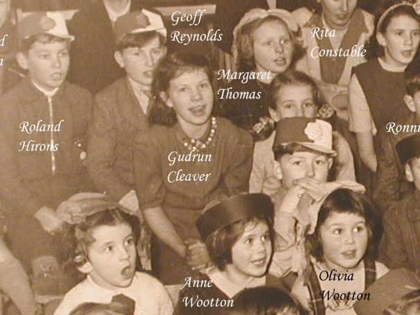 Gudrun can be seen in this 1953 photo taken during a Christmas Party in the school. The children are watching a conjuror!