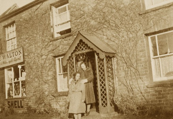 Cecil Walton's daughter Edith (later Edith Parker) on the top step of the cottage with wartime evacuee Renee Barrett c1942. Cecil ran a motor cycle parts and fuel supply business from the garage adjoining the property.